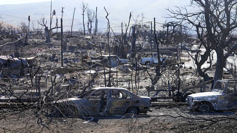 Destroyed homes and cars are shown, Sunday, Aug. 13, 2023, in Lahaina, Hawaii. Hawaii officials...