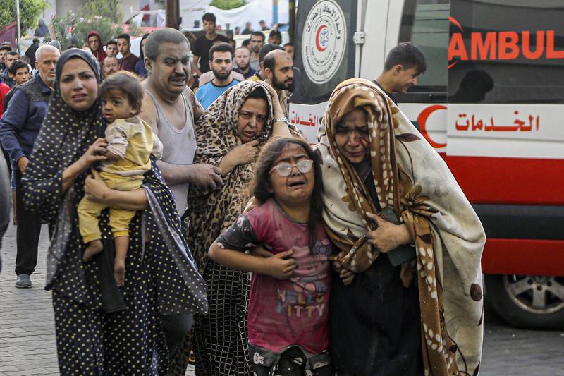 Wounded Palestinians arrive to al-Shifa hospital, following Israeli airstrikes on Gaza City,...